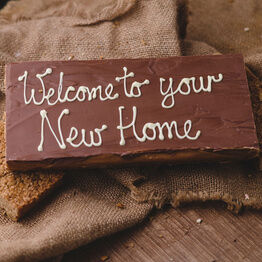 Large Message Flapjack Plaque With White Chocolate Message - Welcome To Your New Home