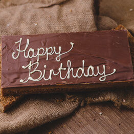 Large Message Flapjack Plaque With White Chocolate Message - Happy Birthday