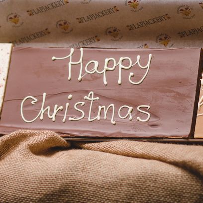 Large Message Flapjack Plaque With White Chocolate Message - Happy Christmas